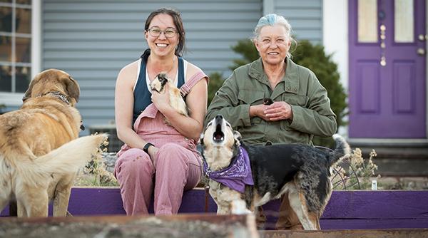 Two women holding animals