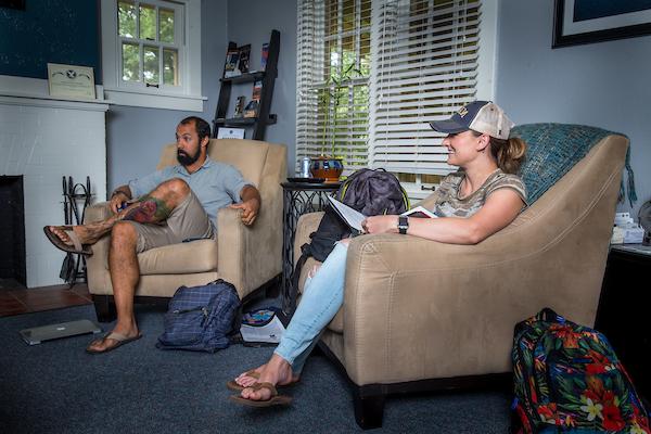 Two students sitting in the living room of Roudebush cottage